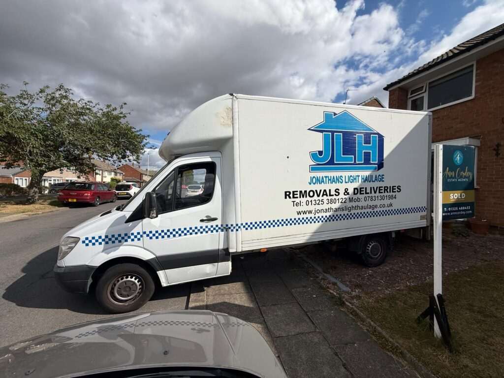 Whatsapp Image 2026-07-30 at 095446 - Jonathan's Light Haulage Darlington White Moving Van with Blue Jlh Logo and 'removals & Deliveries' Parked on a Suburban Street Under Cloudy Sky.